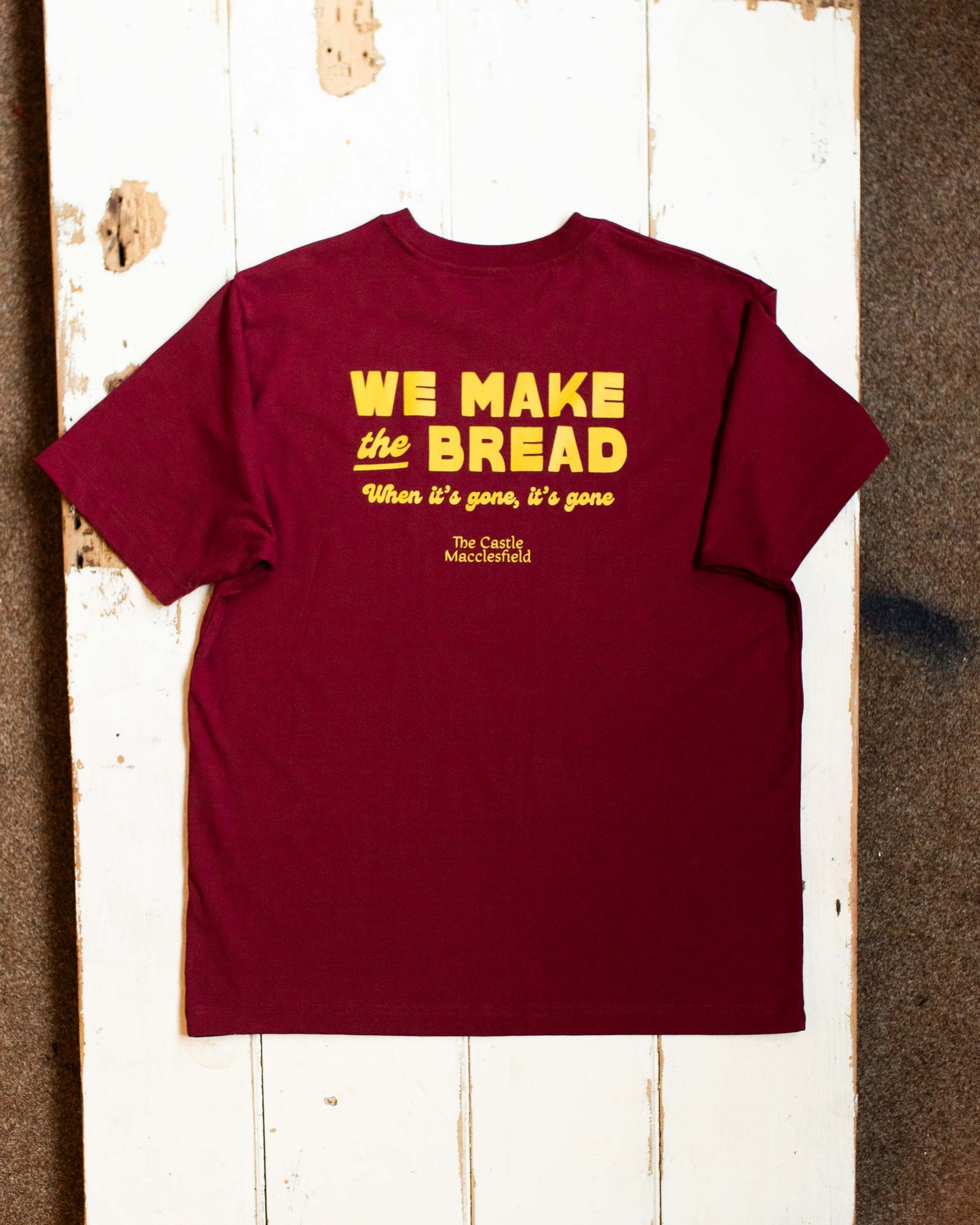 we make the bread, the castle officiale tee in burgundy